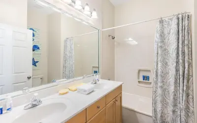 a bathroom with a sink and a mirror at Beach Dreamer by Oversee 30A in Seacrest