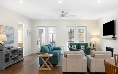 a living room with a couch and chairs and a tv at Beach Dreamer by Oversee 30A in Seacrest