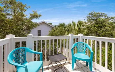 two chairs and a table on a balcony at Bimini by Oversee 30A in Carillon Beach