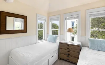 two twin beds in a room with windows at Bimini by Oversee 30A in Carillon Beach