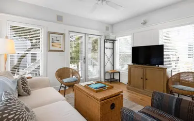 a living room with a couch and a tv at Bimini by Oversee 30A in Carillon Beach