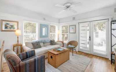 a living room with a couch and a table at Bimini by Oversee 30A in Carillon Beach