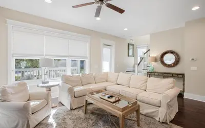 a living room with a white couch and a table at Flatwoods 134 by Oversee 30A in Santa Rosa Beach