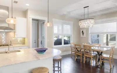 a kitchen and dining room with a table and chairs at Flatwoods 134 by Oversee 30A in Santa Rosa Beach