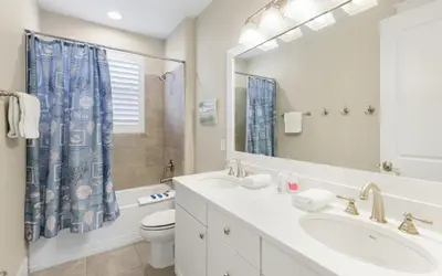 a bathroom with a sink and a toilet and a mirror at Flatwoods 134 by Oversee 30A in Santa Rosa Beach