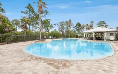 a swimming pool at a resort with a pavilion at Flatwoods 134 by Oversee 30A in Santa Rosa Beach