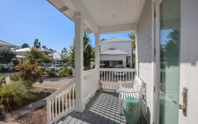 a white porch with a bench on it at Flatwoods 134 by Oversee 30A in Santa Rosa Beach
