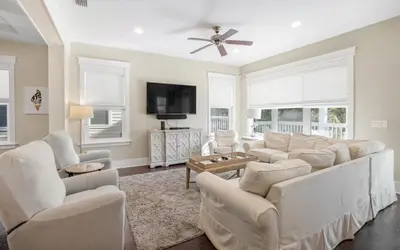 a living room with white furniture and a flat screen tv at Flatwoods 134 by Oversee 30A in Santa Rosa Beach