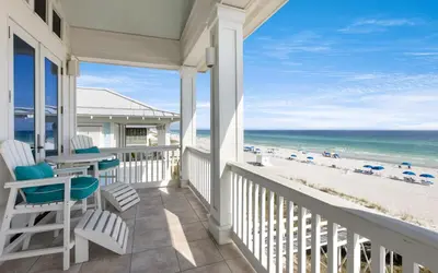 a porch with chairs and a table and the beach at Peaceful Easy Feeling by Oversee 30A in Carillon Beach