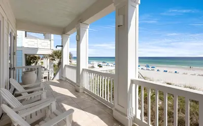 a porch with chairs and a view of the beach at Peaceful Easy Feeling by Oversee 30A in Carillon Beach