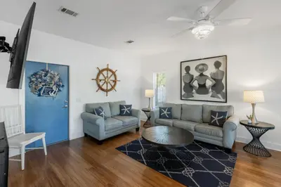 a living room with a couch and a table at Coral Reef by Oversee 30A in Santa Rosa Beach