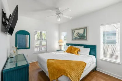 a bedroom with a bed and a ceiling fan at Coral Reef by Oversee 30A in Santa Rosa Beach