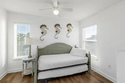 a bedroom with a bed with seahorses on the wall at Coral Reef by Oversee 30A in Santa Rosa Beach