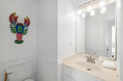 a bathroom with a sink and a mirror at Coral Reef by Oversee 30A in Santa Rosa Beach