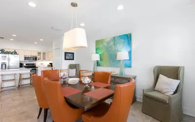 a kitchen and dining room with a table and chairs at Seagrove Villa B202 by Oversee 30A in Santa Rosa Beach