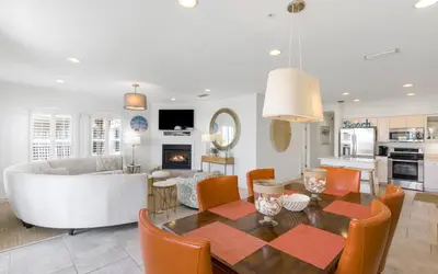 a dining room and living room with a table and chairs at Seagrove Villa B202 by Oversee 30A in Santa Rosa Beach
