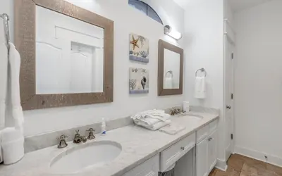 a white bathroom with two sinks and a mirror at Seagrove Villa B202 by Oversee 30A in Santa Rosa Beach