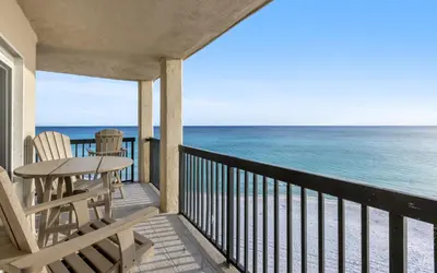 a balcony with a table and chairs and the ocean at Top Shellf by Oversee 30A in Carillon Beach