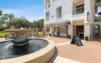 a fountain in a courtyard in front of a building at Top Shellf by Oversee 30A in Carillon Beach