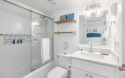 a bathroom with a toilet and a sink and a shower at Top Shellf by Oversee 30A in Carillon Beach