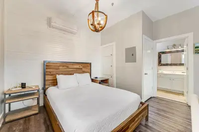 a bedroom with a large white bed and a chandelier at Village of South Walton B248 by Oversee 30A in Inlet Beach