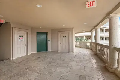 an empty hallway of a house with a exit sign at Village of South Walton B248 by Oversee 30A in Inlet Beach