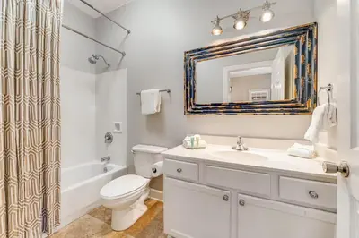 a bathroom with a toilet and a sink and a mirror at Village of South Walton B248 by Oversee 30A in Inlet Beach