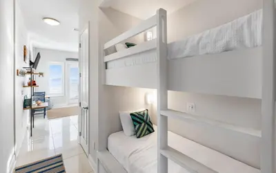 a white bedroom with a bunk bed in it at The Sea Goddess by Oversee 30A in Santa Rosa Beach