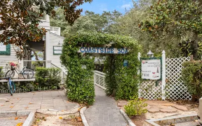 a white fence with a gate with a sign at The Sea Goddess by Oversee 30A in Santa Rosa Beach