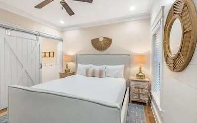 a bedroom with a white bed and a mirror at Casa De La Sirena by Oversee 30A in Seacrest