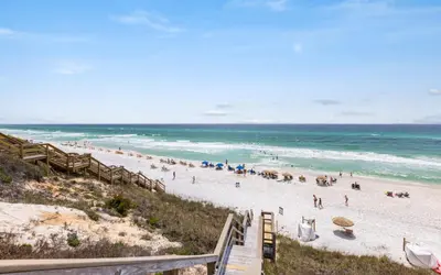 a beach with a crowd of people and the ocean at Casa De La Sirena by Oversee 30A in Seacrest