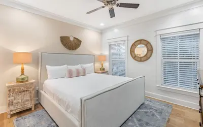 a bedroom with a bed and a ceiling fan at Casa De La Sirena by Oversee 30A in Seacrest