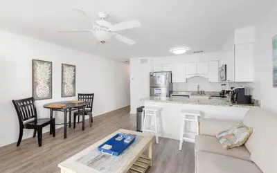 a living room with a couch and a kitchen at Leeward II Unit 4 by Oversee 30A in Santa Rosa Beach