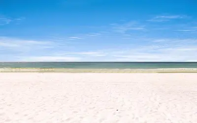 a sandy beach with the ocean in the background at Leeward II Unit 4 by Oversee 30A in Santa Rosa Beach