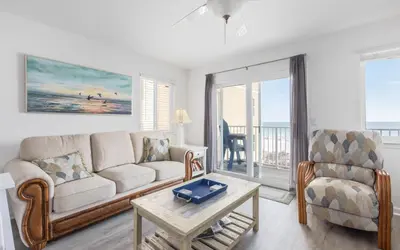a living room with a couch and a chair and a table at Leeward II Unit 4 by Oversee 30A in Santa Rosa Beach