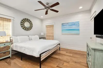 a bedroom with a bed and a ceiling fan at Naut 4 Sail by Oversee 30A in Seacrest