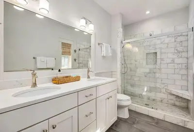 a white bathroom with two sinks and a toilet at Naut 4 Sail by Oversee 30A in Seacrest