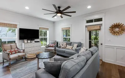 a living room with a couch and a tv at Naut 4 Sail by Oversee 30A in Seacrest