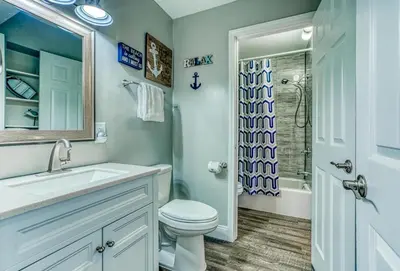 a bathroom with a toilet and a sink and a shower at -BeachFront Premium-Summit 1124 in Panama City Beach