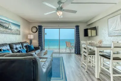 a living room with a couch and a table at -BeachFront Premium-Summit 1124 in Panama City Beach