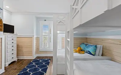 a childs bedroom with a bunk bed with a ladder at Forever and Always by Oversee 30A in Seacrest
