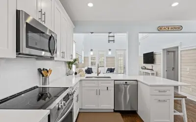 a white kitchen with a sink and a microwave at Forever and Always by Oversee 30A in Seacrest