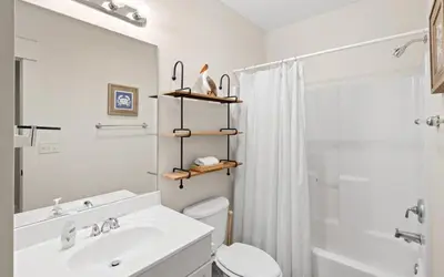 a bathroom with a sink and a toilet and a shower at Oasis By The Water by Oversee 30A in Seacrest