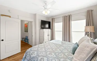 a bedroom with a bed and a ceiling fan at Oasis By The Water by Oversee 30A in Seacrest