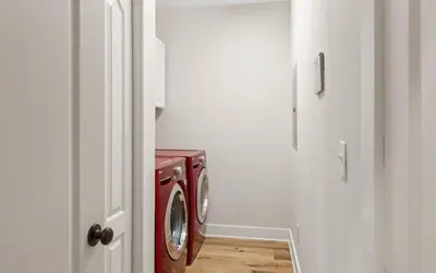 a washer and dryer in a white room at Oasis By The Water by Oversee 30A in Seacrest