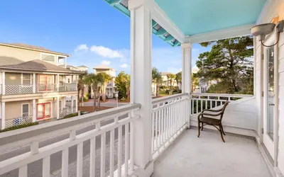 a porch with a chair and a view of a street at The Loopy Crab by Oversee 30A in Seacrest