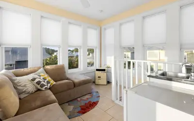 a living room with a couch and a sink at The Loopy Crab by Oversee 30A in Seacrest