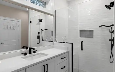 a white bathroom with a sink and a shower at The Loopy Crab by Oversee 30A in Seacrest