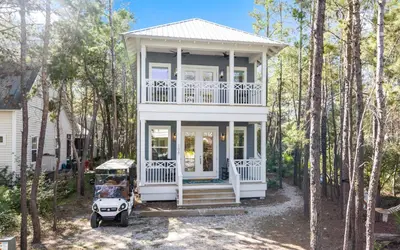a white house with a car parked in front of it at Sweet Lu-Sea by Oversee 30A in Santa Rosa Beach