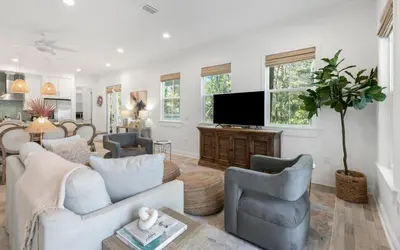 a living room with a couch and a tv at Sweet Lu-Sea by Oversee 30A in Santa Rosa Beach